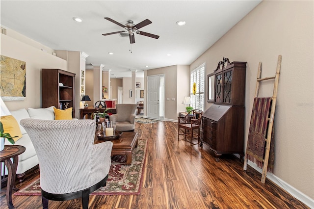 living room featuring dark wood-style flooring, decorative columns, recessed lighting, a ceiling fan, and baseboards