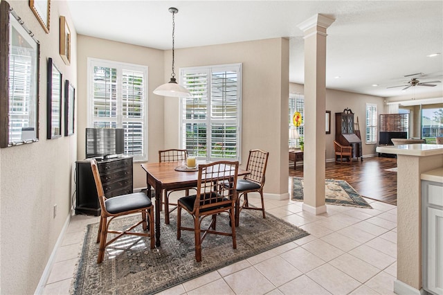 dining area with plenty of natural light, decorative columns, light tile patterned floors, and a ceiling fan