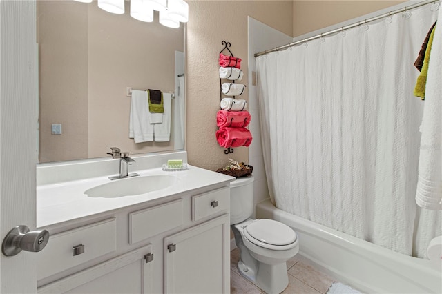 bathroom with a textured wall, tile patterned flooring, toilet, vanity, and shower / tub combo with curtain