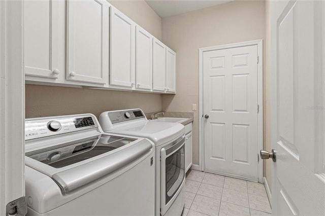 laundry area featuring separate washer and dryer, light tile patterned flooring, a sink, and cabinet space