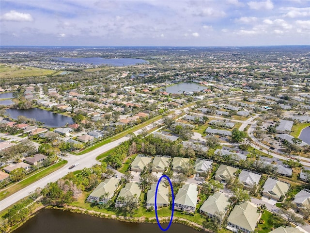 drone / aerial view with a residential view and a water view