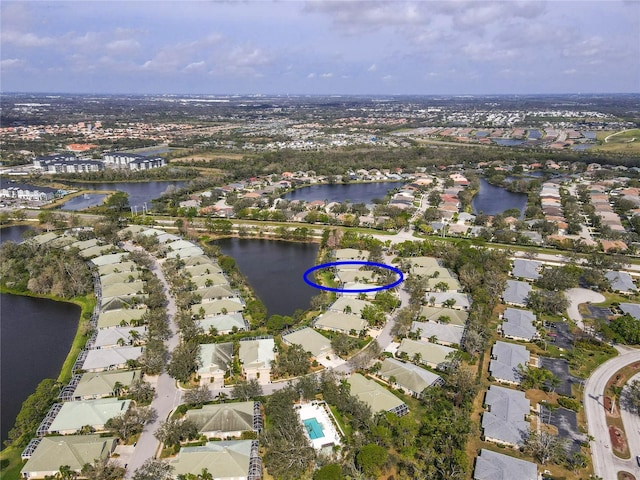 drone / aerial view with a water view and a residential view