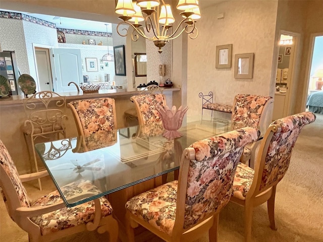 dining area featuring an inviting chandelier and wallpapered walls