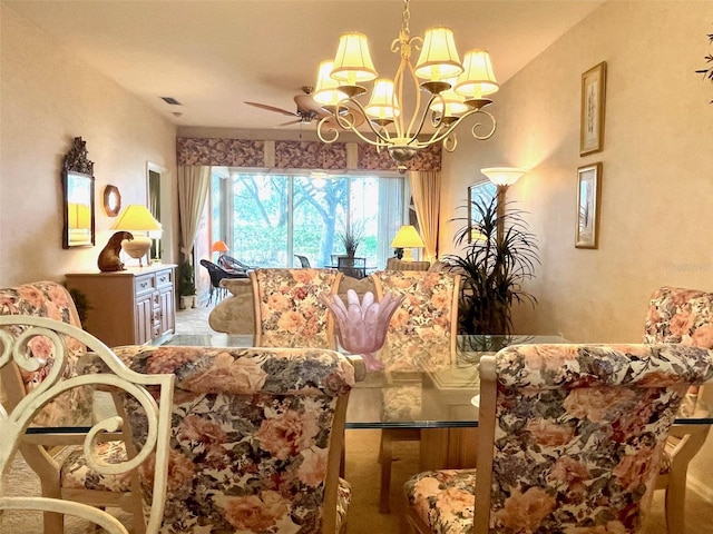 dining space featuring ceiling fan with notable chandelier