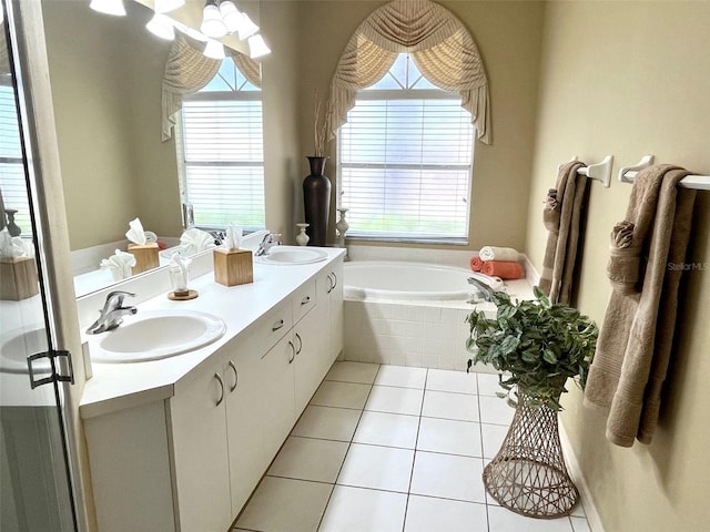 bathroom featuring double vanity, a sink, a bath, and tile patterned floors