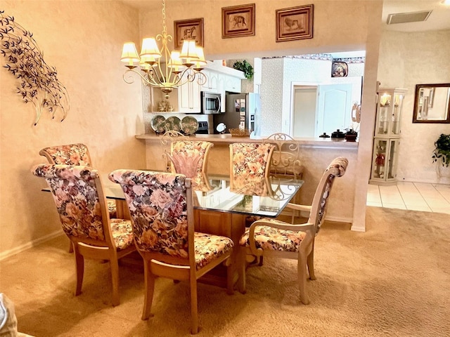 dining room with light carpet, light tile patterned floors, baseboards, and a notable chandelier