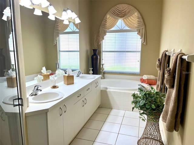 full bathroom with double vanity, tile patterned flooring, a sink, and a bath