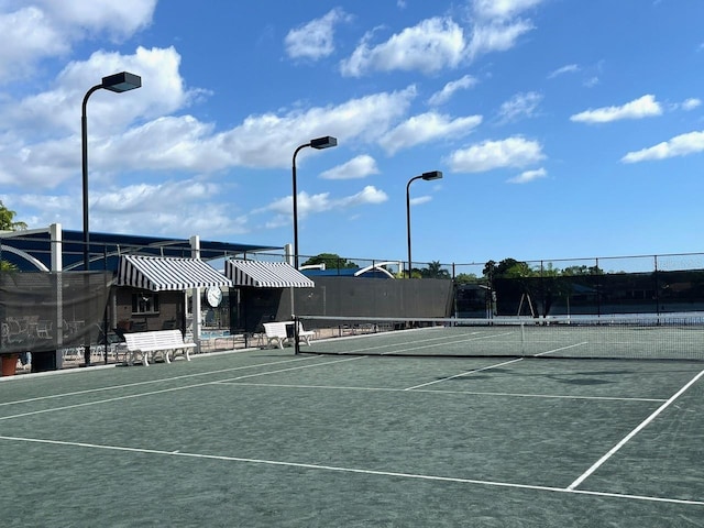 view of tennis court with fence