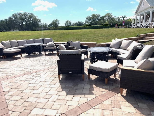 view of patio / terrace featuring an outdoor living space with a fire pit