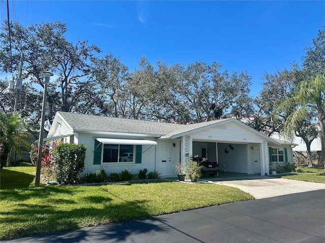 single story home with an attached carport, a front lawn, and concrete driveway