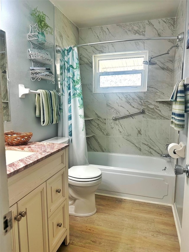 full bathroom with toilet, shower / bath combo, wood finished floors, and vanity