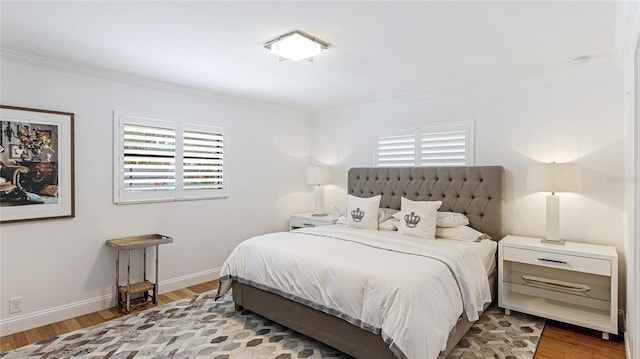 526 Bird Key Dr, Sarasota, FL 34236 - bedroom featuring crown molding, wood finished floors, and baseboards
