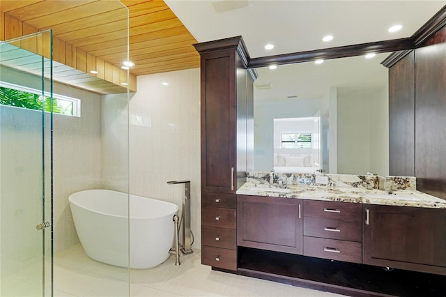 526 Bird Key Dr, Sarasota, FL 34236 - full bathroom with ensuite bathroom, a freestanding tub, double vanity, and tile patterned floors