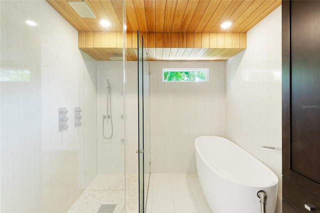 526 Bird Key Dr, Sarasota, FL 34236 - full bath with a tile shower, a freestanding tub, wood ceiling, tile patterned floors, and recessed lighting