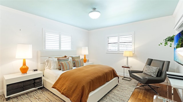 526 Bird Key Dr, Sarasota, FL 34236 - bedroom with light wood-style flooring, baseboards, and crown molding