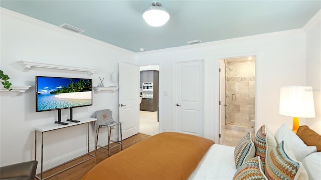 526 Bird Key Dr, Sarasota, FL 34236 - bedroom featuring ornamental molding, wood finished floors, ensuite bath, and baseboards