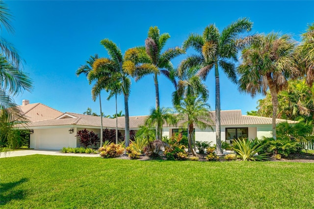 526 Bird Key Dr, Sarasota, FL 34236 - single story home with an attached garage, a front yard, concrete driveway, and a tile roof