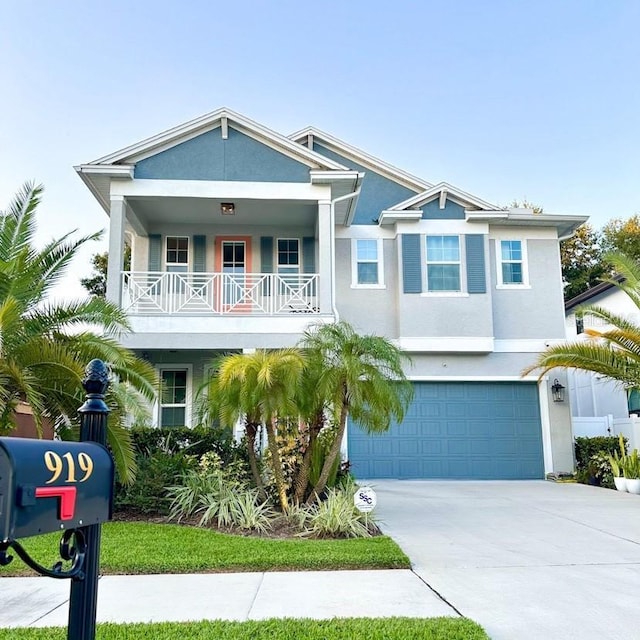 view of front of house with a garage, concrete driveway, and stucco siding