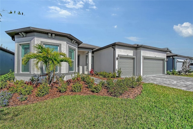 view of front of property featuring an attached garage, stucco siding, decorative driveway, and a front yard