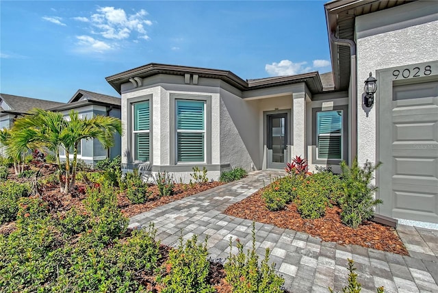 entrance to property featuring stucco siding