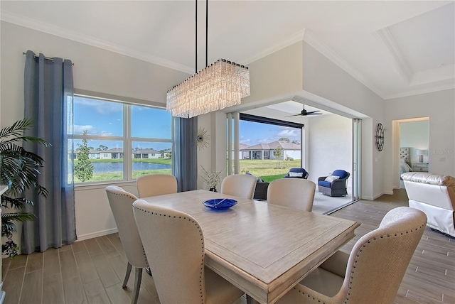 dining room with ornamental molding, light wood-style flooring, and baseboards