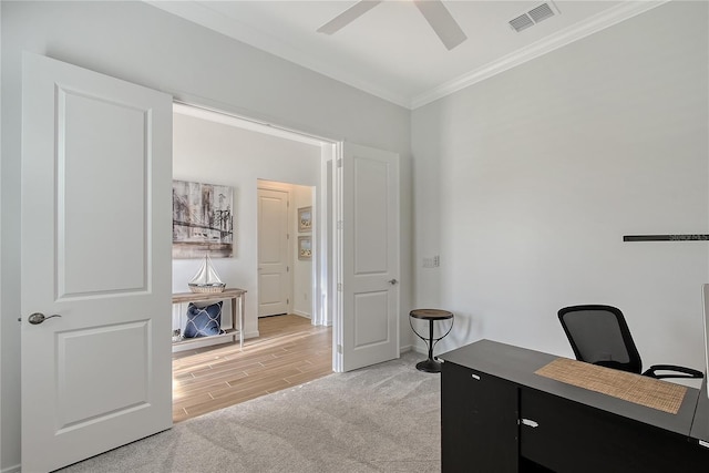 office space featuring visible vents, baseboards, ceiling fan, ornamental molding, and light wood-type flooring