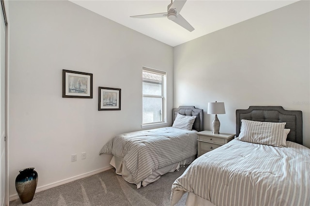 bedroom with light colored carpet, ceiling fan, and baseboards