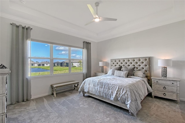 bedroom featuring carpet, a raised ceiling, ceiling fan, and baseboards