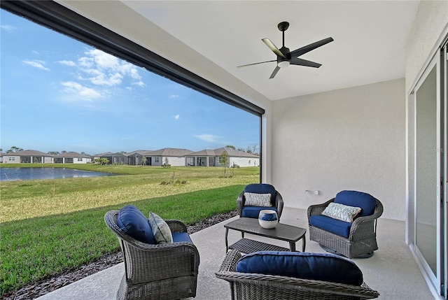 view of patio with a ceiling fan, a residential view, and a water view