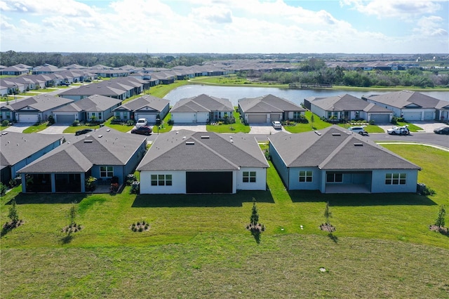 drone / aerial view featuring a water view and a residential view