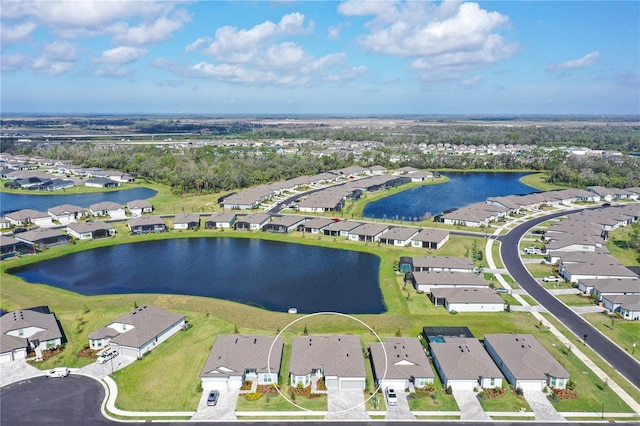 drone / aerial view featuring a water view and a residential view