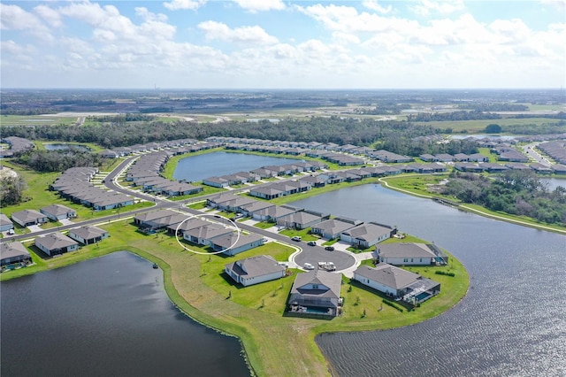 drone / aerial view featuring a water view and a residential view