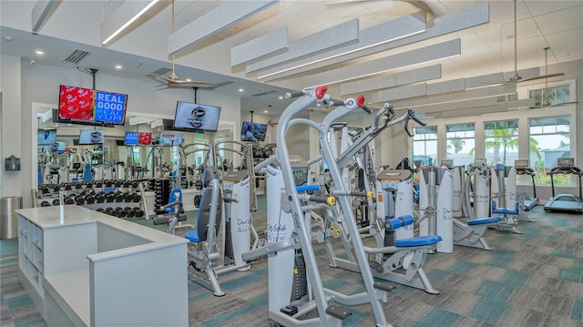 exercise room with carpet flooring and visible vents