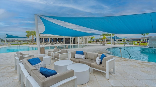 pool featuring outdoor lounge area and a patio