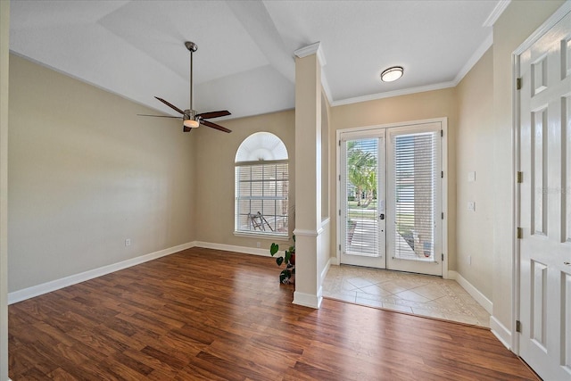 foyer entrance with hardwood / wood-style flooring, ceiling fan, and crown molding