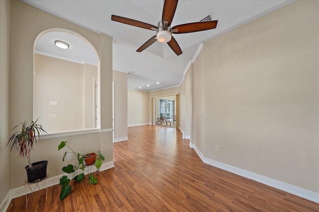 empty room featuring ceiling fan, ornamental molding, and wood-type flooring