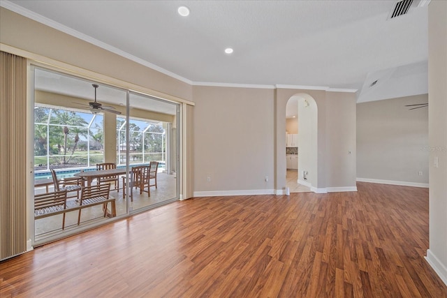 unfurnished room with ceiling fan, crown molding, and hardwood / wood-style floors