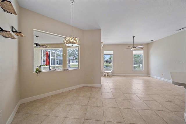 unfurnished room with ceiling fan and light tile patterned floors