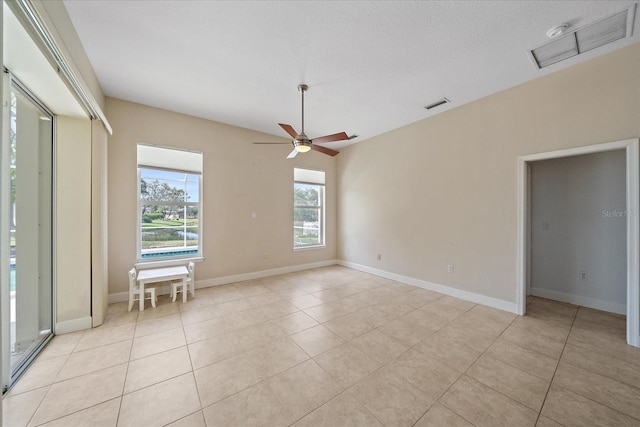 tiled spare room with ceiling fan