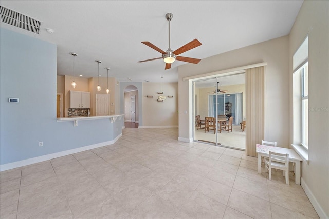 spare room with ceiling fan and light tile patterned floors