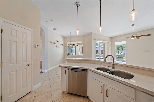 kitchen with sink, dishwasher, white cabinets, and decorative light fixtures