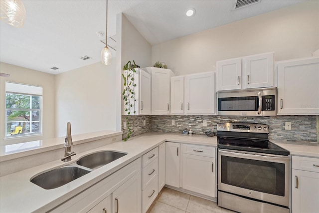 kitchen with sink, stainless steel appliances, hanging light fixtures, and white cabinets