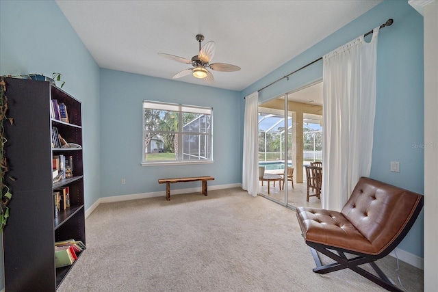 sitting room with carpet and ceiling fan