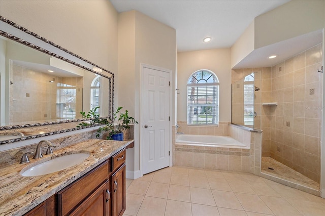 bathroom featuring plus walk in shower, vanity, and tile patterned floors