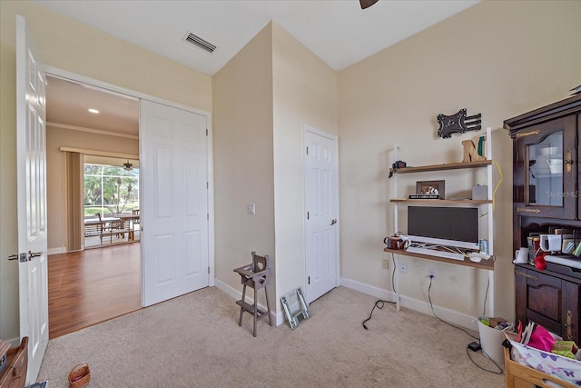 interior space featuring light carpet and ceiling fan