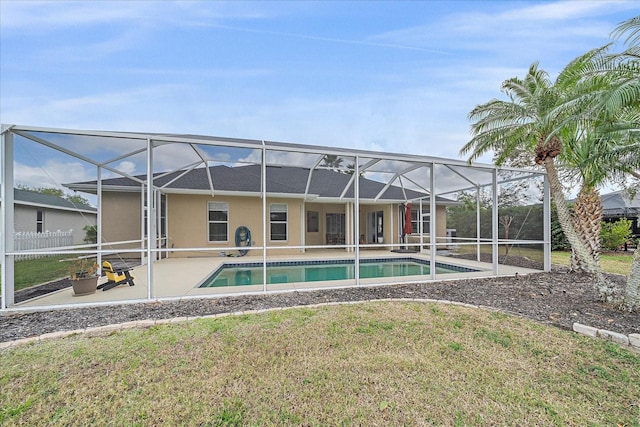 rear view of house with a yard, a lanai, and a patio area