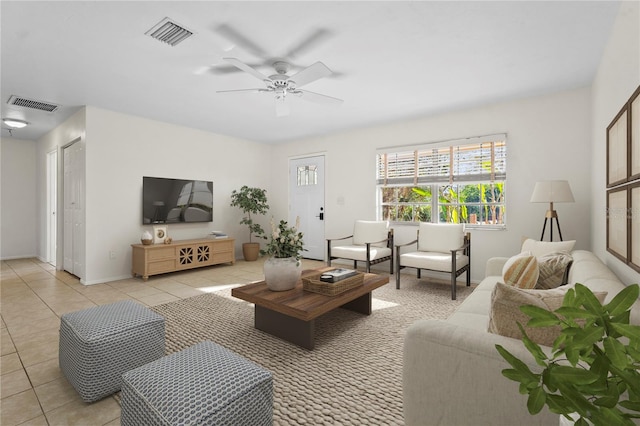 living room featuring light tile patterned floors, visible vents, and a ceiling fan