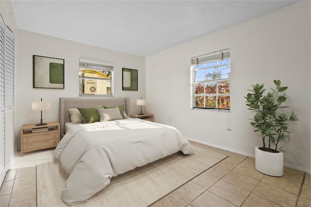 bedroom featuring baseboards and light tile patterned flooring