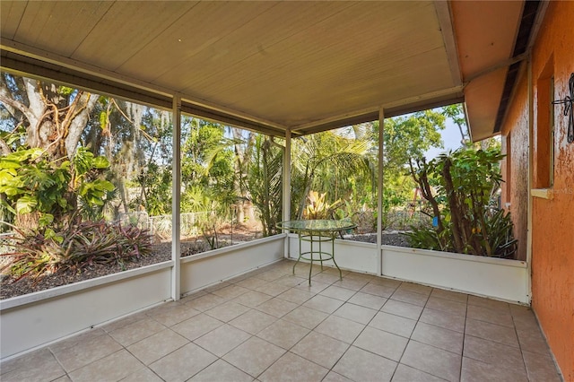 unfurnished sunroom featuring wood ceiling