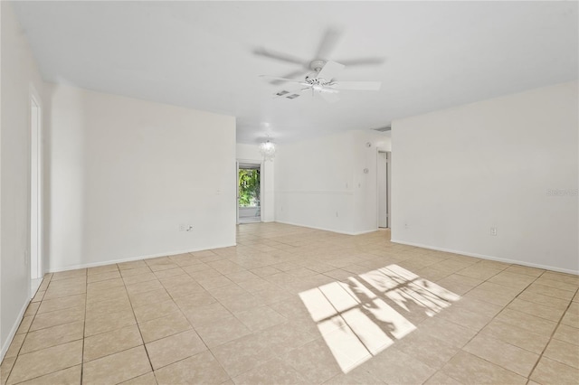 unfurnished room with a ceiling fan, visible vents, baseboards, and light tile patterned floors